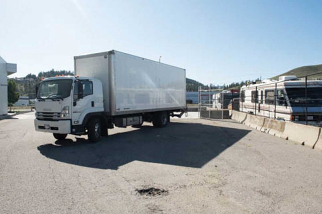 Red lock storage cube van coming into lot