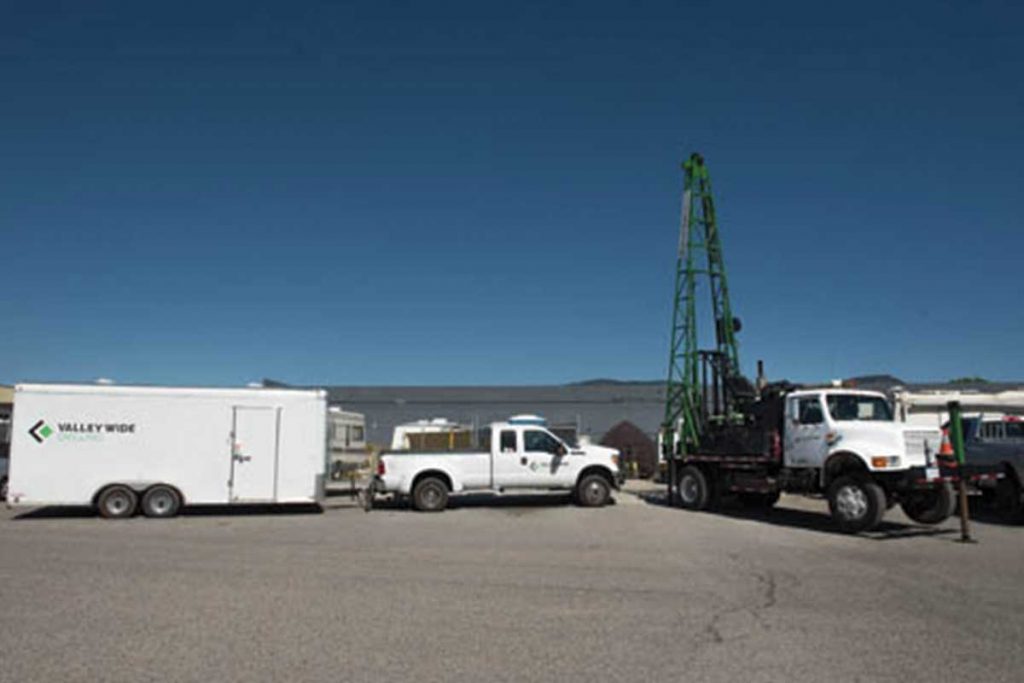 Red lock storage white truck with long trailer on lot